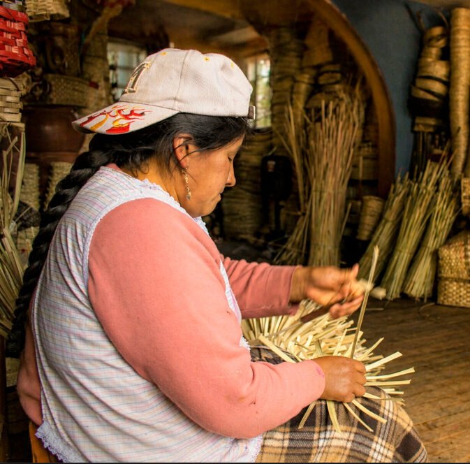 Artesano tejiendo cestería